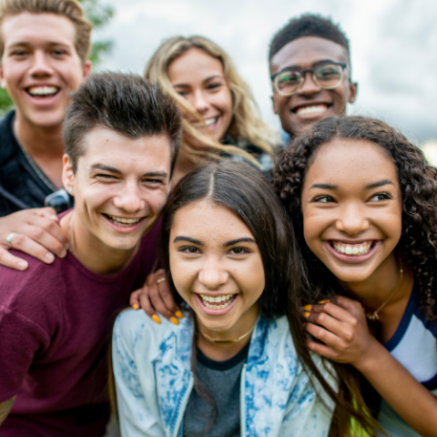 A diverse group of teens smiling