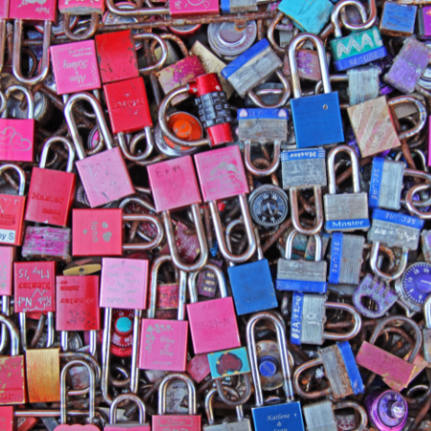 a pile of colorful padlocks on a wall