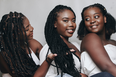 Three Black women with different hair styles.