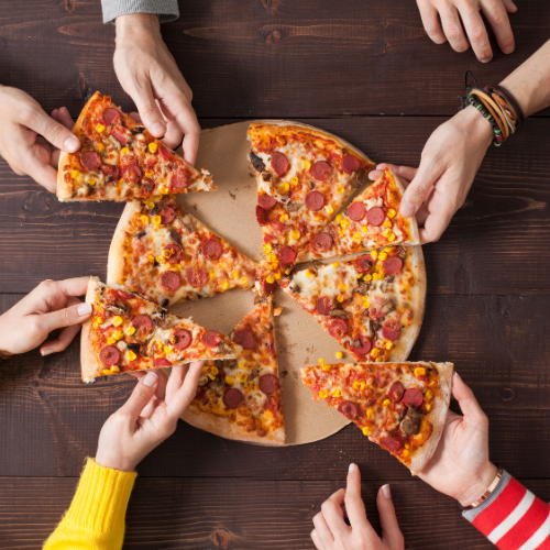 Hands grabbing pizza