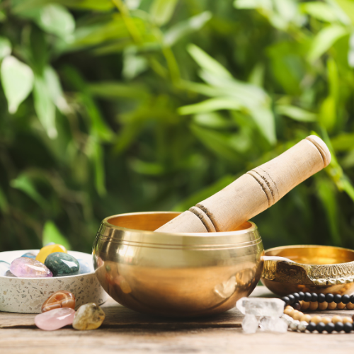 a wooden table with a bowl of herbs, stones and other items