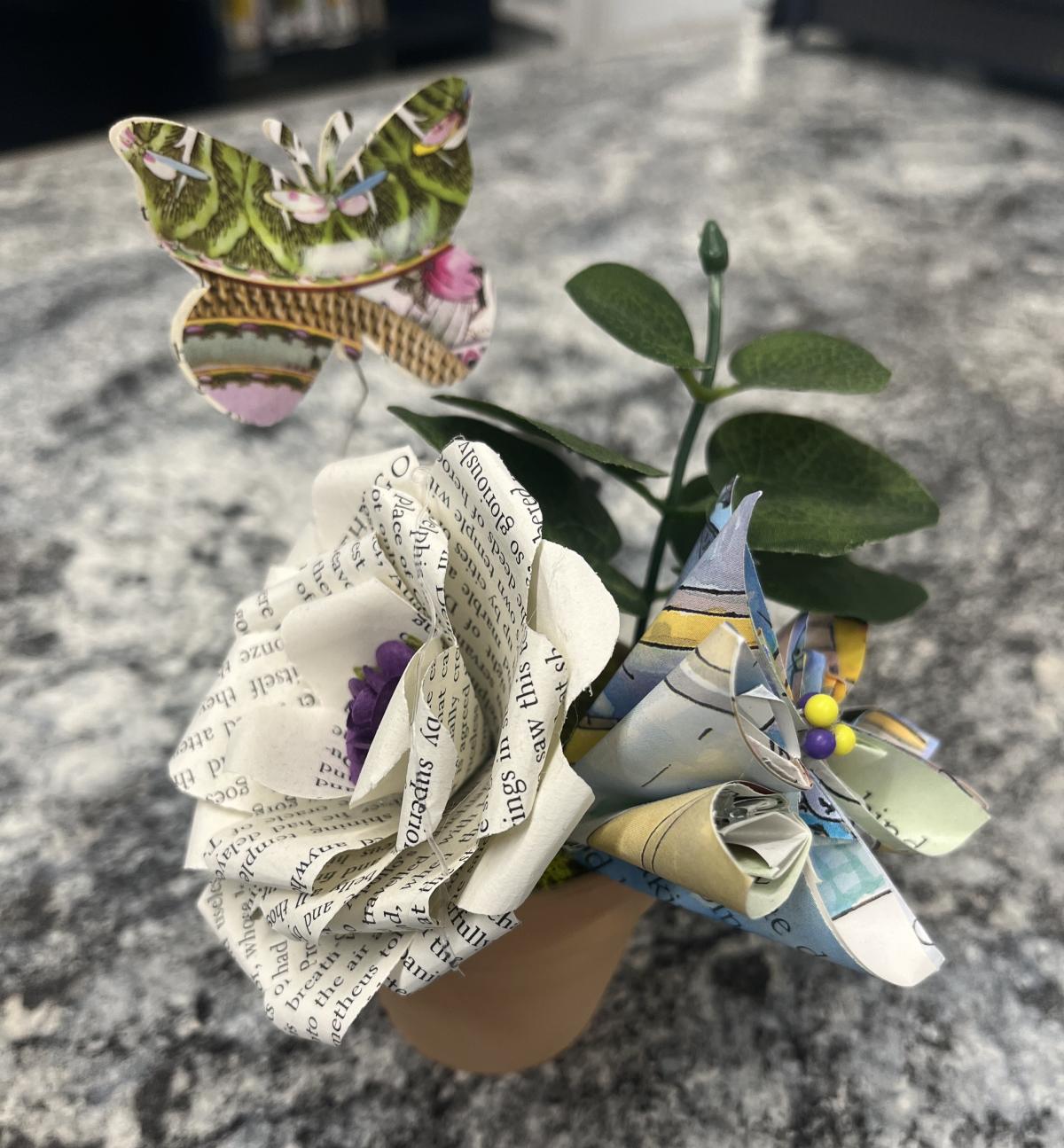 Paper flowers and butterfly in terracotta pot