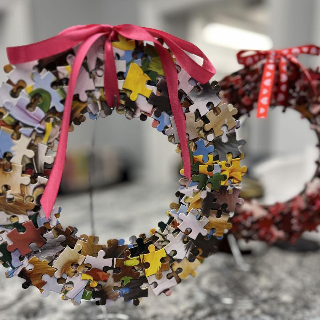 Wreaths made out of puzzle pieces with decorated with ribbons