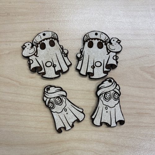 laser cut earrings sitting on a table