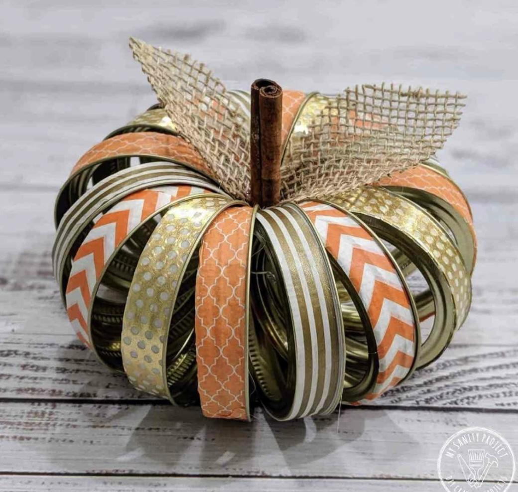 Canning lids with ribbon in the shape of a pumpkin with a cinnamon stick stem