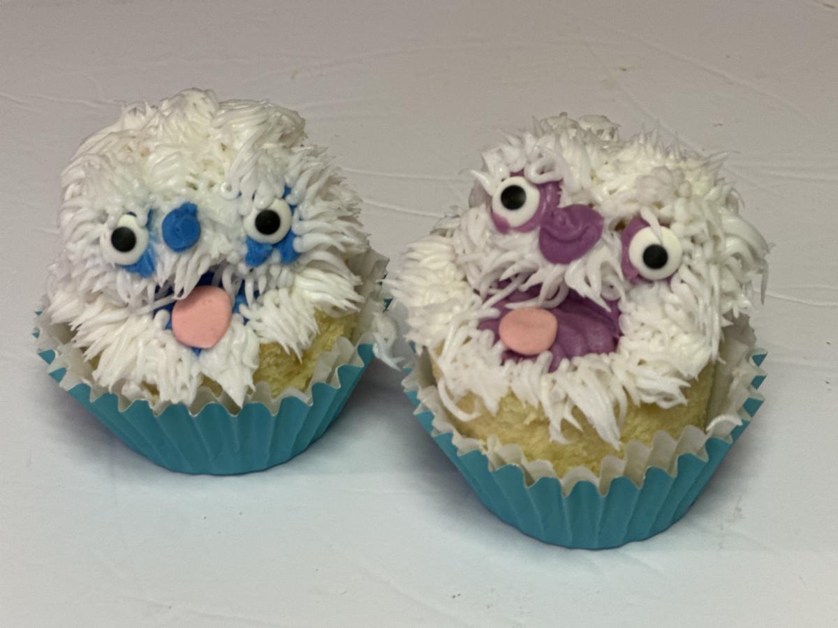 Two cupcakes decorated to look like yetis.